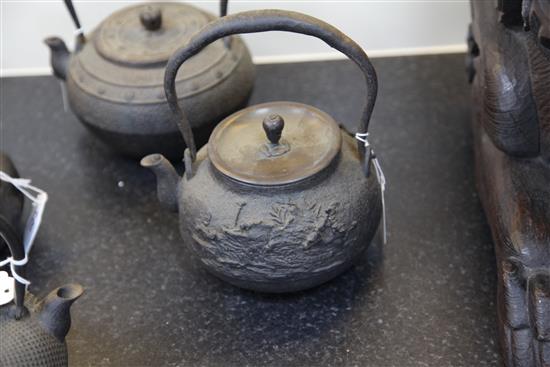 Five Japanese cast iron teapots, two with lacquer covers, 19th century, largest 19cm wide